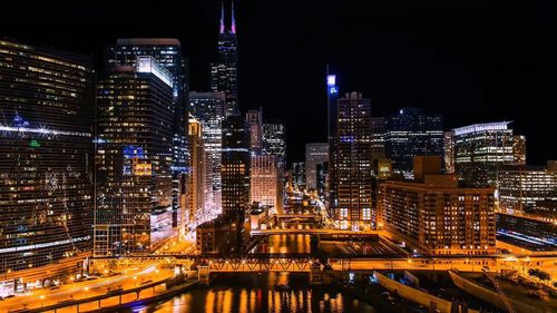 Illuminated buildings in city at night,chicago river from 360 n. michigan