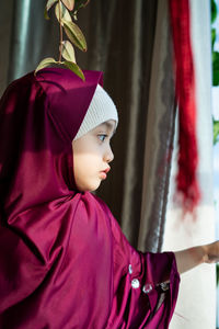 Portrait of a happy muslim toddler girl with hijab. natural light, selective focus.