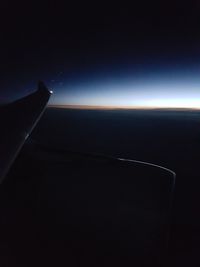 Cropped image of airplane flying over landscape