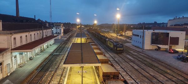 Railroad tracks in city against sky