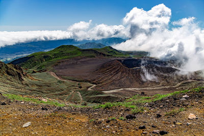 Scenic view on volcanic landscape, clouds in aso crater, aso town in kyushu, japan