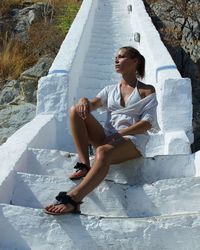 Young woman sitting on old staircase