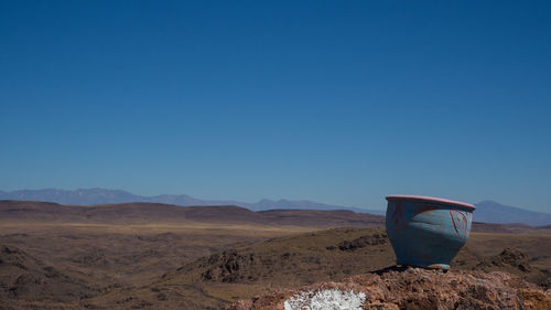 Scenic view of desert against clear blue sky