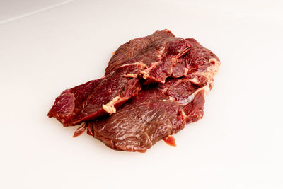 Close-up of meat on white background