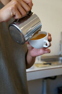 Cropped hand holding coffee at home