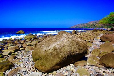 Scenic view of sea against clear blue sky