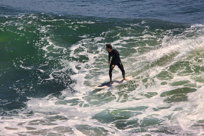 Full length of man surfing in sea