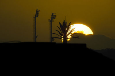 Silhouette landscape against clear sky during sunset