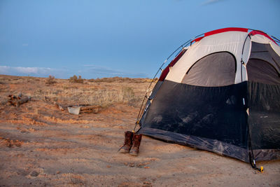 Tent on field against sky