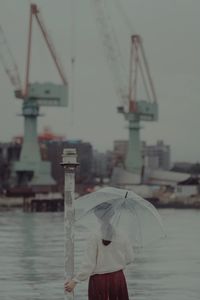 Man holding umbrella during rainy season