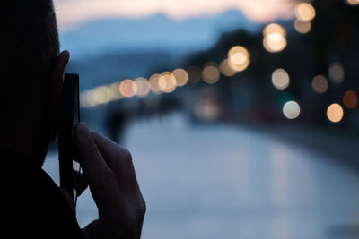 Cropped image of man talking through smart phone