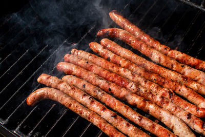 High angle view of meat on barbecue grill