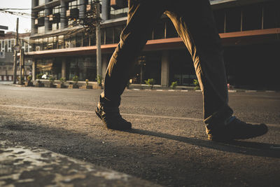 Low section of man on road in city