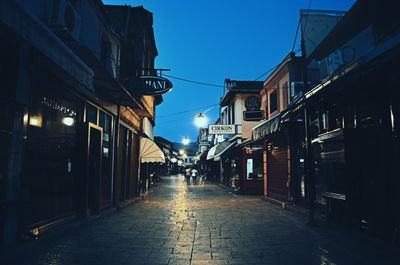 City street against sky at dusk