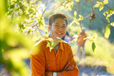 Portrait of smiling young man standing outdoors