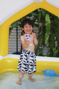 Portrait of cute girl playing with toy on slide at home