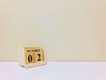 Close-up of information sign on table