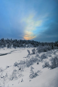 Snow covered landscape against sky