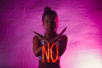 Full length of woman standing against pink blue sea