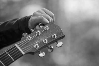 Hand of man playing guitar