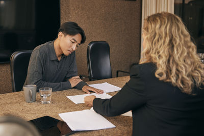 Side view of woman using laptop at home