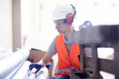 Young woman working in a workshop as artisan manual worker