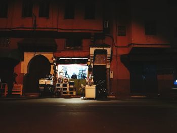 Woman in illuminated city at night