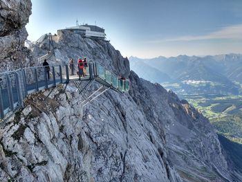 People standing on dachstein mountains during sunny day
