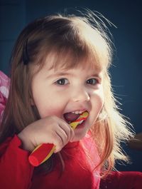 Portrait of girl brushing teeth