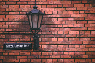 Street light mounted on brick wall