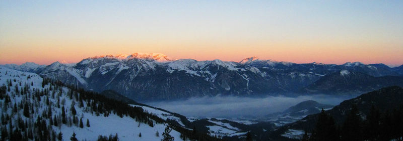 Scenic view of snow mountains against sky during sunset