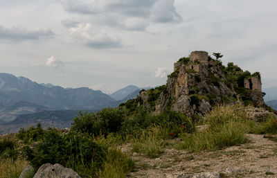 Scenic view of mountain against cloudy sky