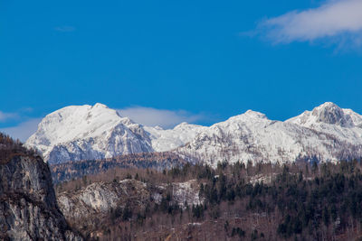 Scenic view of mountains against blue sky