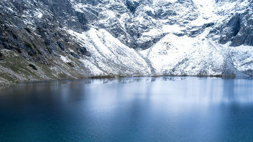 Czarny staw pod rysamy or black pond lake near the morskie oko snowy mountain hut in polish tatry