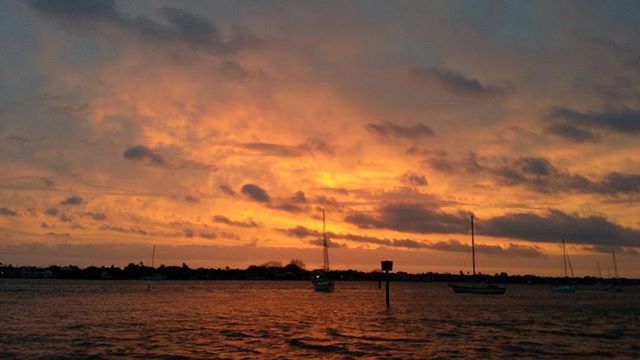 sunset, nautical vessel, transportation, mode of transport, water, boat, sky, sea, waterfront, cloud - sky, scenics, beauty in nature, tranquil scene, tranquility, orange color, nature, silhouette, cloudy, idyllic, moored