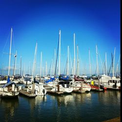 Boats moored at harbor