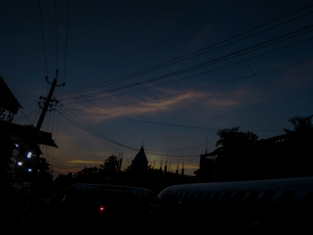 CARS ON CITY AGAINST SKY AT SUNSET