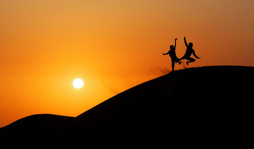 Silhouette of mountain against clear sky at sunset