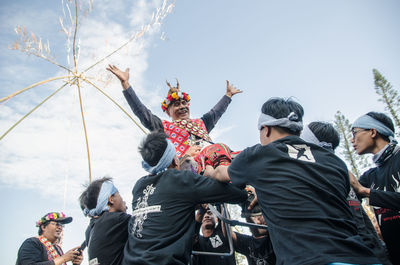 Low angle view of people enjoying in sky