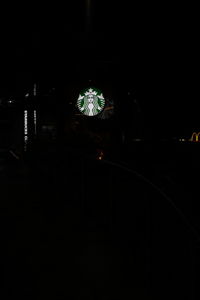 Illuminated christmas lights in building at night