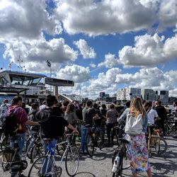 People on street against sky in city