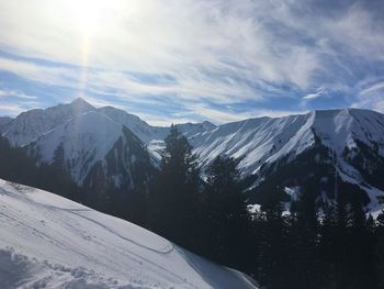 Scenic view of snowcapped mountains against sky