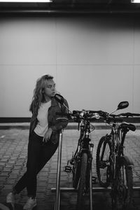 Woman standing by bicycle at basement
