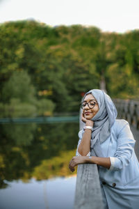 Smiling woman wearing hijab looking away