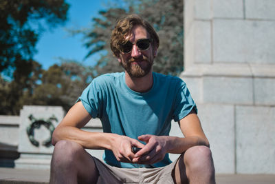 Man in sunglasses sitting outdoors