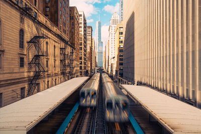 Low angle view of bridge and buildings against sky