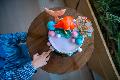 Underwater mermaid cake on the wooden table. top view.