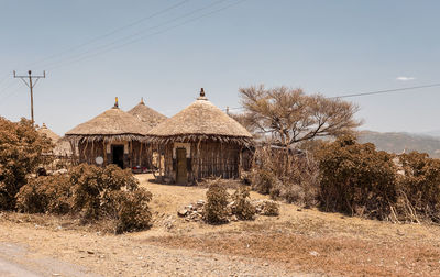 House on field against clear sky