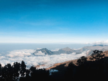 Scenic view of silhouette mountains against blue sky