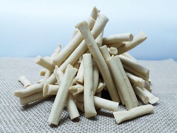 Close-up of carrots on table against white background